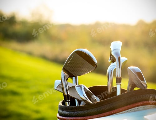 Preview: Golf clubs drivers over green field background