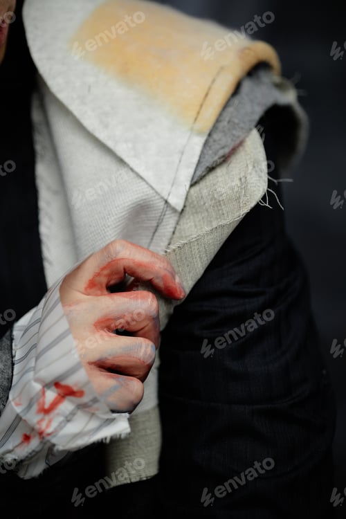 Preview: Hand of Man Wearing Padded Shoulder Jacket in Patchwork Design in Studio