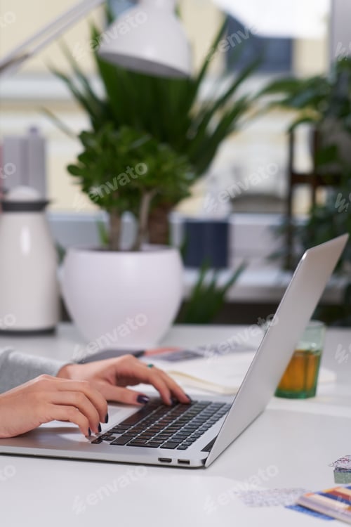 Preview: Woman with manicure is typing on laptop