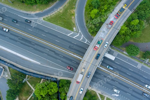 Preview: Busy highway interchange during daytime with vehicles navigating multiple lanes and exits