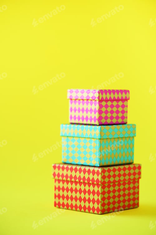 Preview: Collection of colorful gift boxes on yellow background. Presents for birthday and party. Christmas