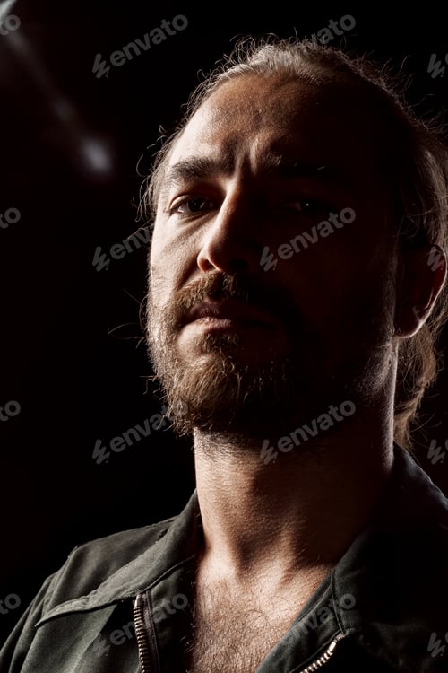 Preview: Close up portrait of a serious pensive middle-aged bearded man