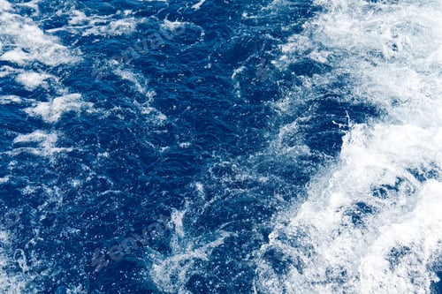 Preview: Abstract blue sea water with white waves. Blue sea texture with waves and foam. Mediterranean sea