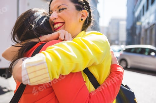 Preview: Women hugging in street, Milan, Italy