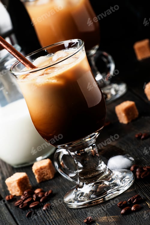 Preview: Iced coffee in glass, milk, sugar and coffee maker, dark background, selective focus