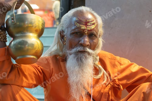 Preview: Ascetic monk Sadhu in India with beard, white hair and painted face preaching