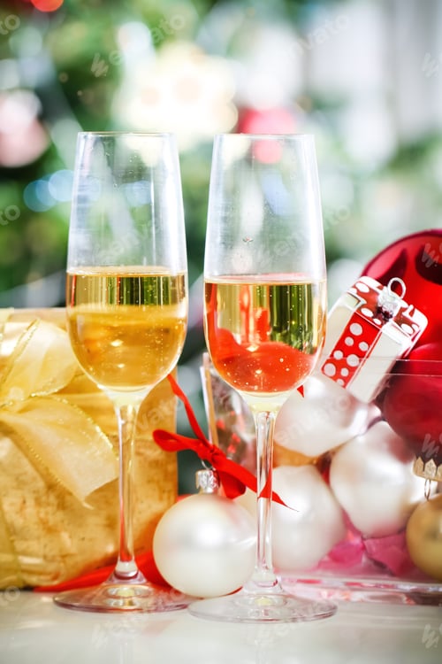 Preview: Glasses of champagne and Christmas decorations