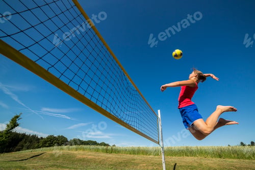 Preview: Germany, Young woman playing beach volleyball