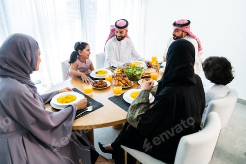 Preview: Happy arab family wearing saudi arabia clothing at home
