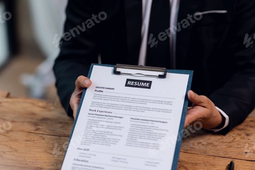 Preview: Executive reading an hr audit resume during a job interview and businessman Completing Application