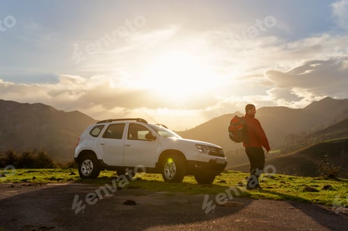 Preview: Hiker with backpack watches the sunset