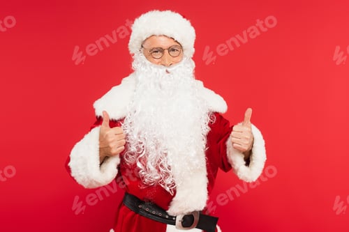 Preview: Santa claus in costume showing like gesture isolated on red