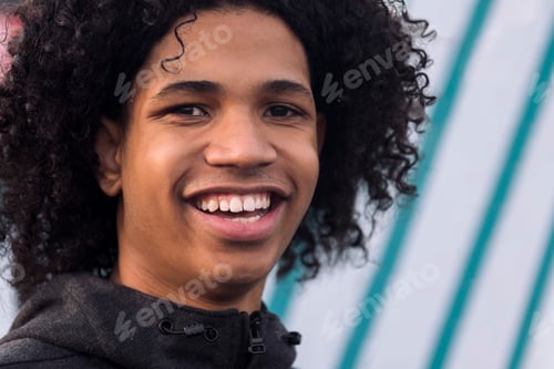 Preview: black male teenager with curly hair smiling happy