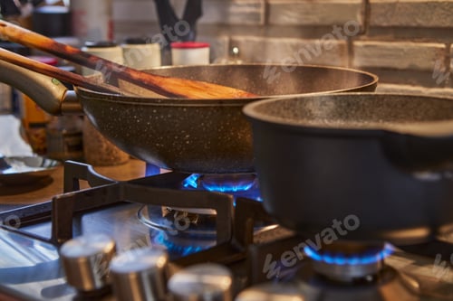 Preview: Frying pan and saucepan on the gas stove while cooking