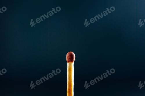 Preview: Front close view of unburned one match on dark background
