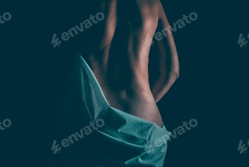 Preview: Undress elegant woman. Studio fashion photo.