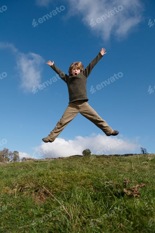 Preview: Boy jumping on hill