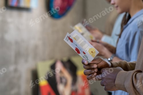 Preview: People reading brochures at exhibition