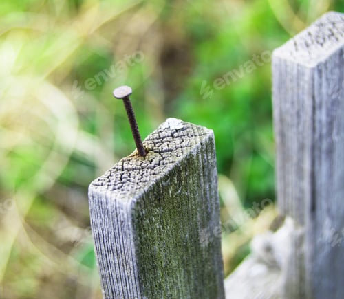 Preview: Old wooden fence and a rusty nail sticking out