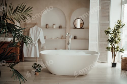 Preview: Luxury interior of big bathroom at modern african style with oval bathtub in natural lighting
