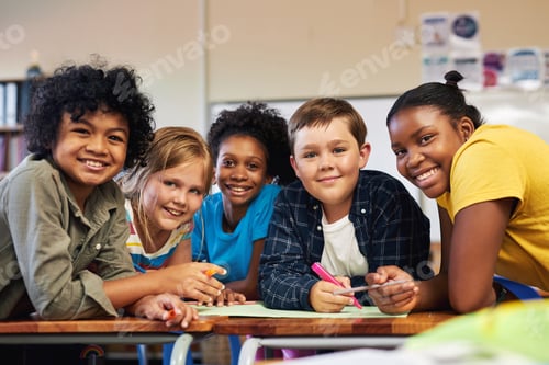 Preview: Shot of a diverse group of children huddled together and colouring in their classroom at school