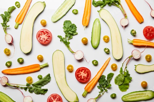 Preview: top view of fresh sliced vegetables on white background