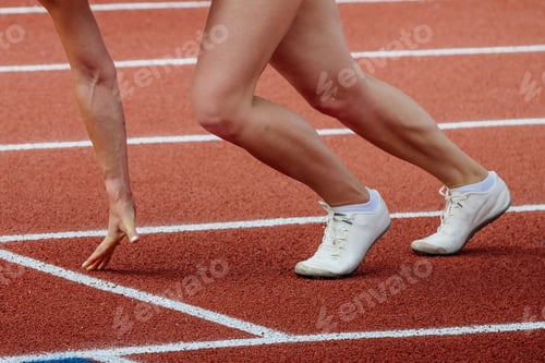 Preview: female athlete runner starting position run sprint race red track stadium
