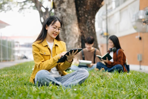 Preview: Asian Students are studying the campus park. Young people are spending time together.