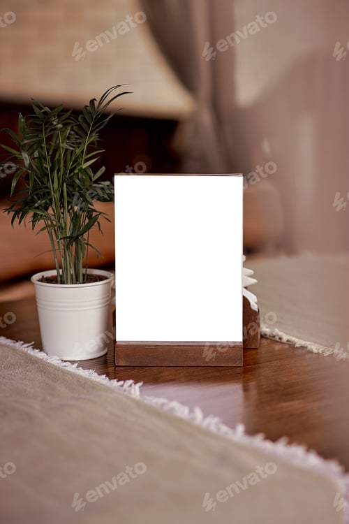 Preview: Mock up of restaurant nameplate among restaurant decoration: linen and flowerpot.