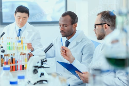 Preview: young doctors in uniform working at testing laboratory, laboratory technicians