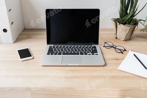 Preview: workplace with laptop computer and supplies in modern office
