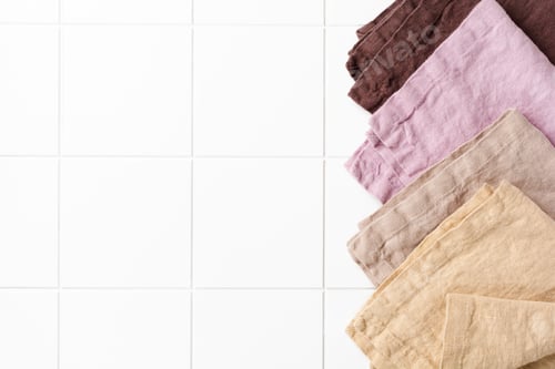 Preview: Four multi-colored napkins on cooking stone table with kitchen towel or napkin. Top view with space