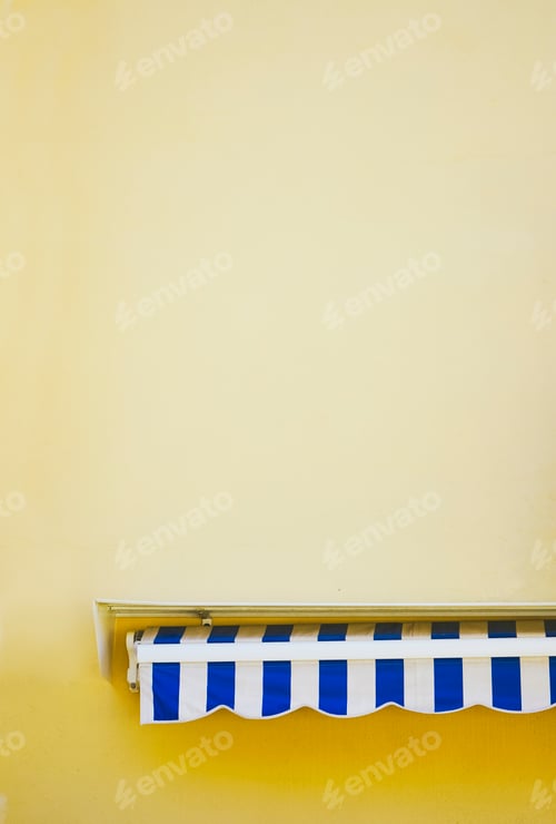 Preview: Retro striped awning agains a yellow wall