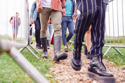 Preview: Close Up Of Friends At Entrance To Music Festival Walking Through Security Barriers