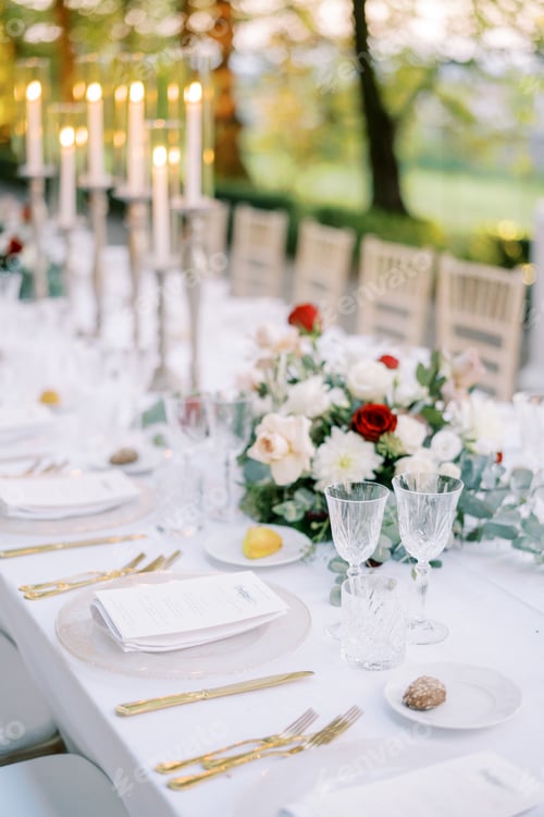 Preview: Festive table with cookies on plates, bouquets of flowers and lit candles