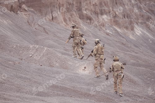 Vista previa: Soldiers in camouflage military uniforms carrying weapons Reconnaissance missions in rugged mountain
