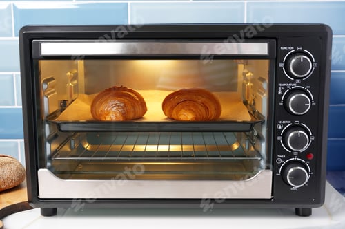 Preview: Modern mini electric oven with freshly baked croissants in kitchen