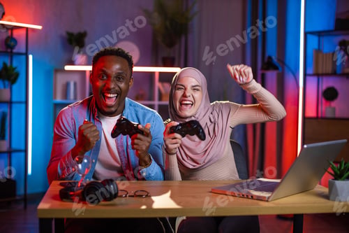 Preview: Diverse couple feeling happiness while win in video games
