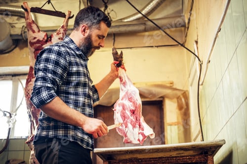Preview: Bearded butcher cut fresh bacon meat.