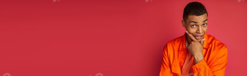 Preview: pensive and tense african american man in orange shirt looking at camera on red, banner, copy space