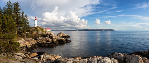 Preview: Lighthouse on a rocky coast during a cloudy evening