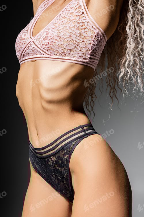 Preview: cropped view of woman with toned body and wavy ash blonde hair standing and posing in lace panties