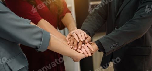Preview: Teamwork business concept of group of three coworkers join hand together during their meeting.