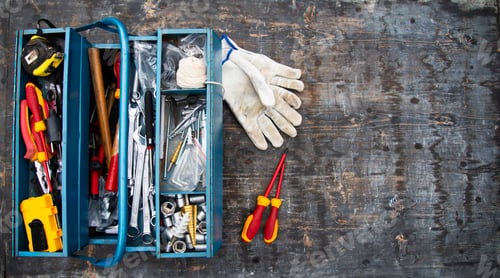 Preview: An open tool box photographed from above with many different tools in it.