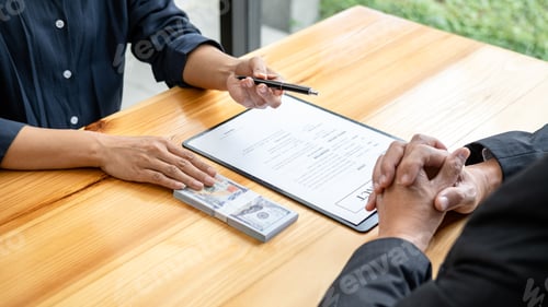 Preview: Bribe employer is handing over a pen and offer terms to businessman for signing on contract