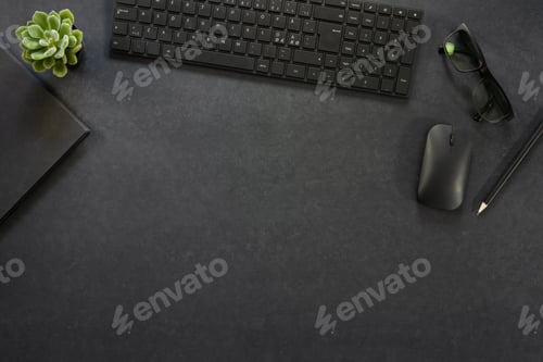 Preview: Top view of black concrete office desk with computer and supplies