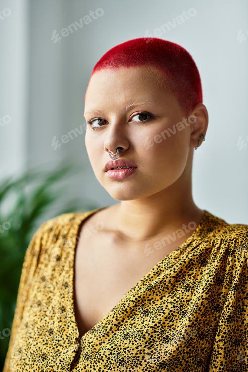 Preview: A striking portrait of a confident bald woman with vibrant red hair in natural light