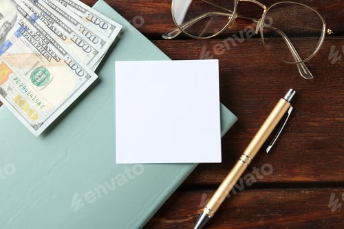 Preview: Alimony. Paper note, notebook, pen, money and glasses on wooden table, flat lay