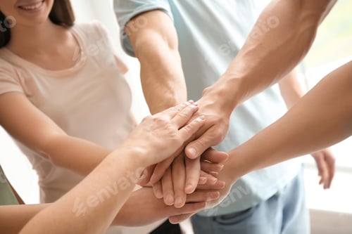 Preview: People putting hands together, closeup. Unity concept