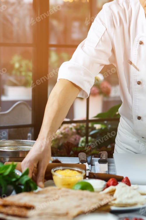 Preview: Hand touching plate with strawberries